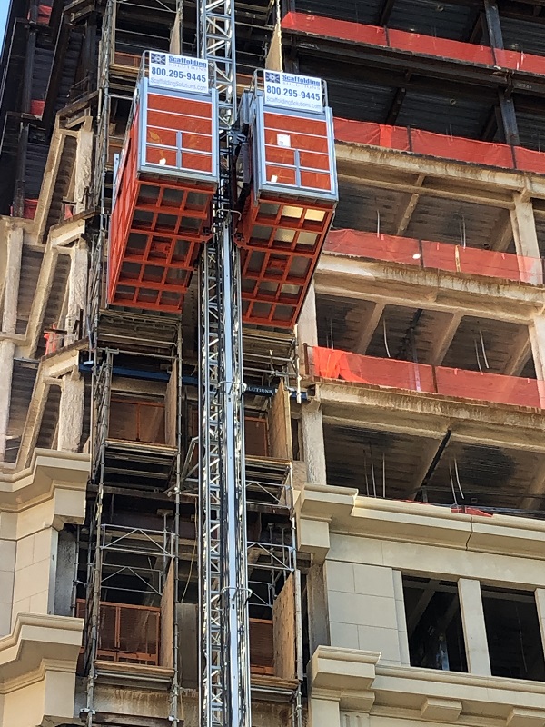 A buck hoist construction elevator on a high-rise building