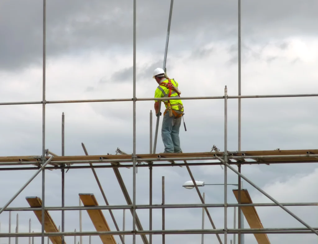 worker walking on scaffolding.