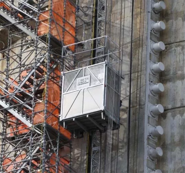 A material hoist moving construction materials up the side of a building.